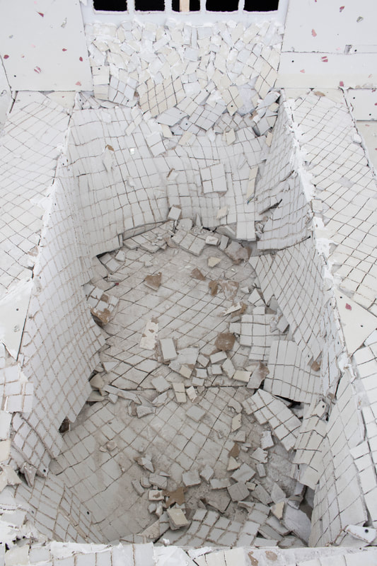 A detail of the interior of the fountain bottom, where the sheetrock crumbles severely and the structure seems at its utmost stage of precarity. Because of the sheetrock, it is powdery and very dry.